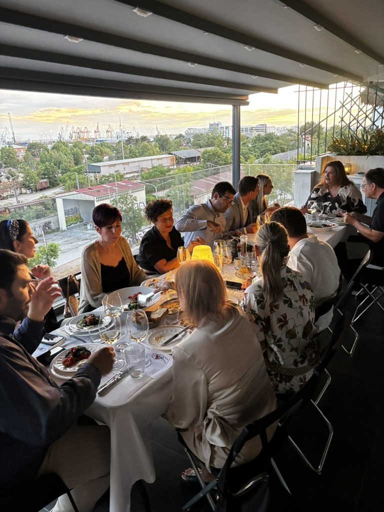guests seated along the table as the light goes gold
