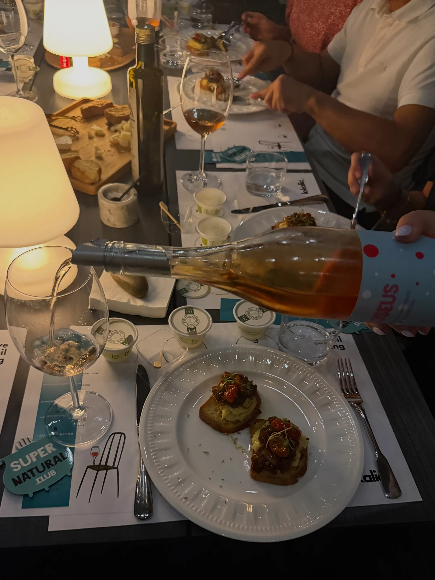 Lemnian dishes served with wine at the long table
