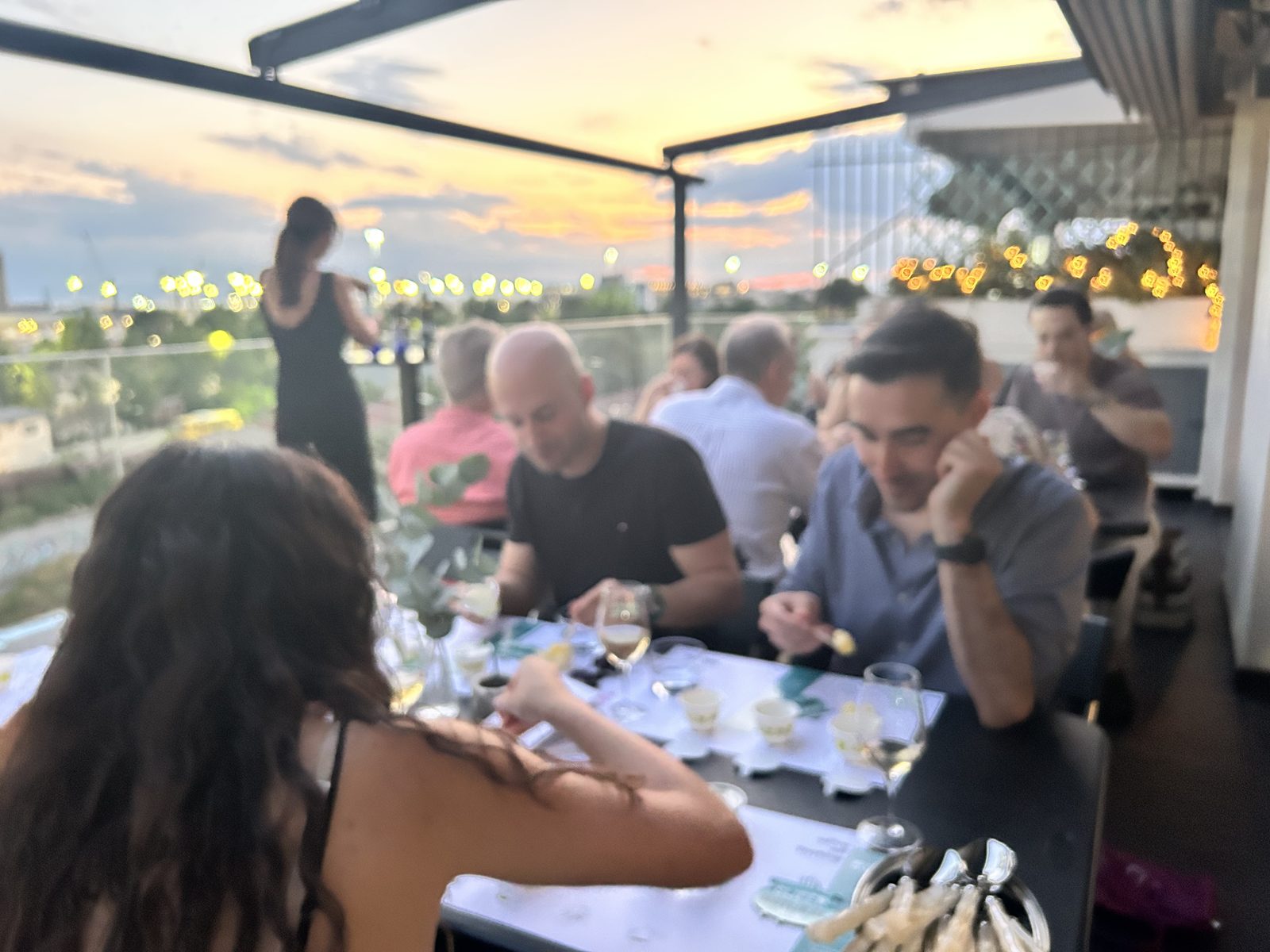the table at sunset, glasses poured and plates shared