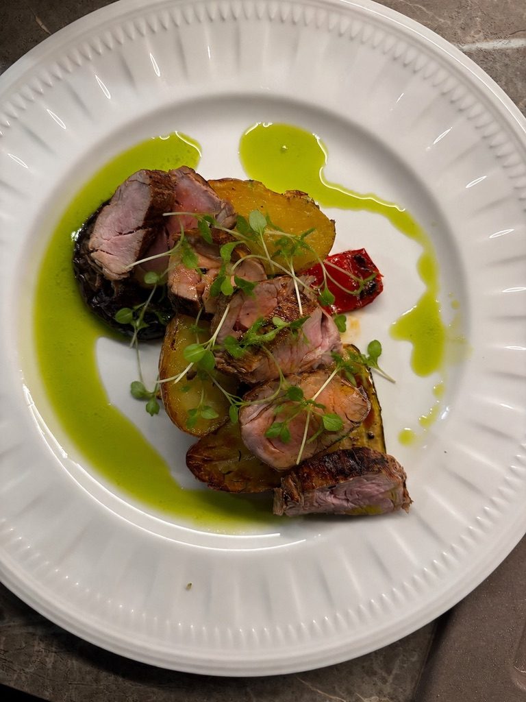 a plated course dressed with green olive oil