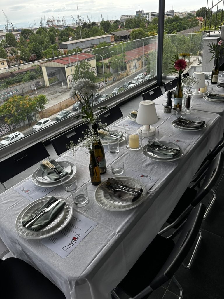 the long table laid with linen and glassware, port beyond