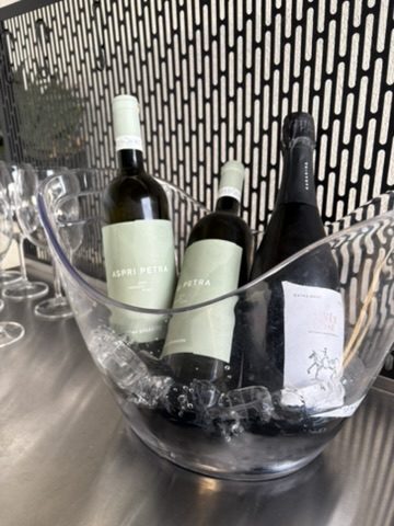 wine bottles cooling in a glass ice bucket