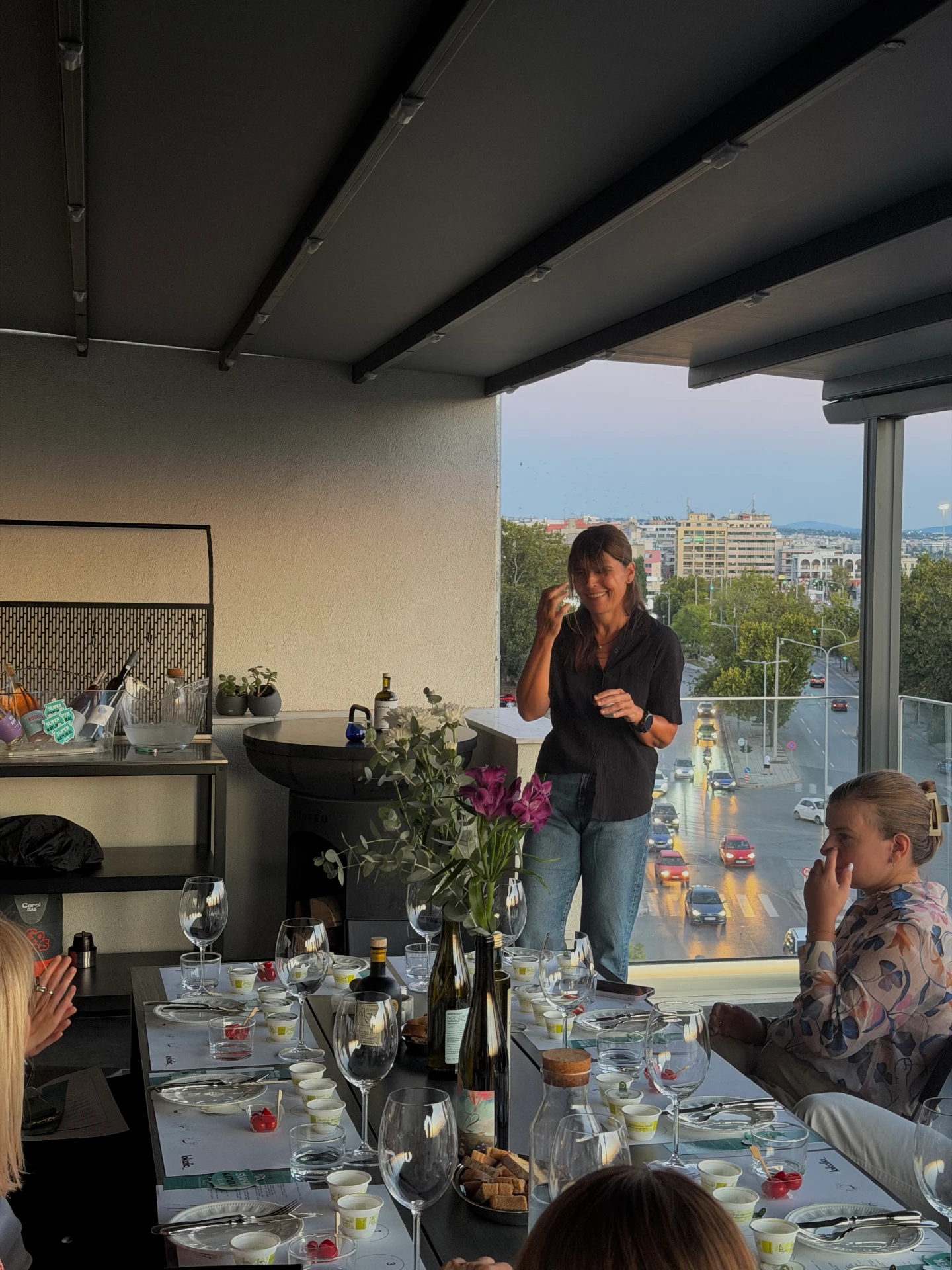 the host welcoming guests on the terrace